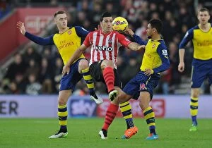 Southampton v Arsenal 2014-15 Collection: Clash at St. Mary's: Arsenal's Chambers and Coquelin Battle Pelle of Southampton (2014-15)