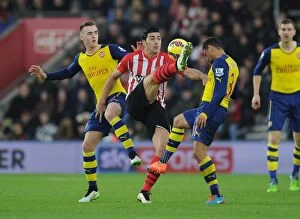 Southampton v Arsenal 2014-15 Collection: Clash at St. Mary's: Chambers, Coquelin's Defiant Performance Against Pelle's Southampton (2014-15)