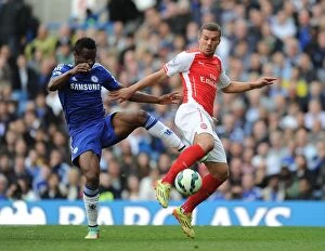 Chelsea v Arsenal 2014-15 Collection: Clash at Stamford Bridge: Lukas Podolski vs. John Mikel Obi, Premier League Showdown