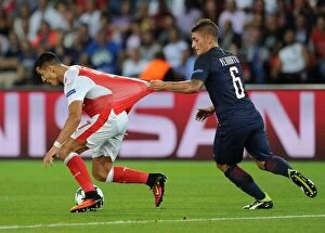 Paris Saint Gernain v Arsenal 2016-17 Collection: Clash of Stars: Alexis Sanchez and Marco Verratti Lock Horns in Tense PSG vs Arsenal Champions