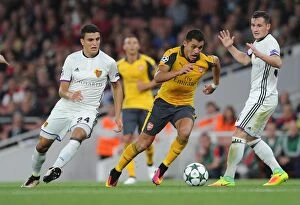 Arsenal v FC Basel 2016-17 Collection: Clash of Stars: Alexis Sanchez vs. Mohamed Elyounoussi in Arsenal's UEFA Champions League Battle