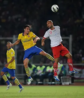 Indonesia Dream Team V Arsenal 2013-14 Prints: Clash of Stars: Ignasi Miquel vs. Sergio Van Duk (Arsenal vs. Indonesia All-Stars, 2013)
