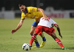 Indonesia Dream Team V Arsenal 2013-14 Prints: Clash of Stars: Jenkinson vs. Sanadi in Arsenal's Encounter with Indonesia All-Stars