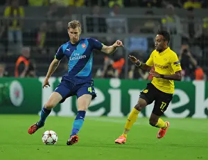 Borussia Dortmund V Arsenal 2014-15 Prints: Clash of Stars: Per Mertesacker vs