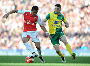 Arsenal V Norwich City 2015-16 Prints: Clash of Stars: Sanchez vs. Brady in Arsenal's Battle Against Norwich City