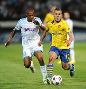 Images Dated 18th September 2013: Clash of Talents: Wilshere vs. Ayew - Marseille vs. Arsenal, UEFA Champions League, 2013