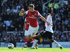 Images Dated 20th April 2013: Clash on the Thames: Ramsey vs. Enoh in Fulham vs. Arsenal Premier League Battle