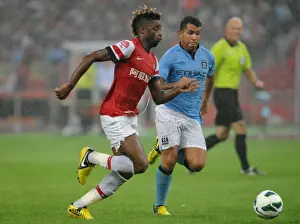 Clash of Titans: Alex Song vs. Carlos Tevez - Arsenal FC vs. Manchester City