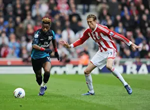 Stoke City V Arsenal 2011-12 Prints: Clash of Titans: Alex Song vs. Peter Crouch - Arsenal vs