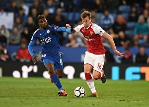 Leicester City v Arsenal 2017-18 Collection: Clash of Titans: Holding vs Iheanacho - A Battle for Premier League Supremacy