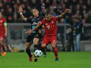 Bayern Munich V Arsenal 2015-16 Prints: Clash of Titans: Kieran Gibbs vs Arturo Vidal - Battle at the Allianz Arena
