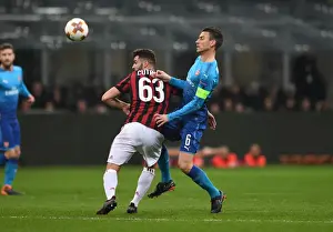 AC Milan V Arsenal 2017-18 Prints: Clash of Titans: Koscielny vs. Cutrone in the Europa League Showdown - Arsenal vs