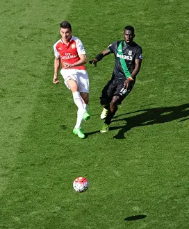 Arsenal V Stoke City 2015-16 Prints: Clash of Titans: Koscielny vs. Diouf in Intense Arsenal-Stoke Battle