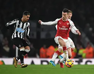 Arsenal V Newcastle United 2017-18 Prints: Clash of Titans: Koscielny vs. Perez in Arsenal's Battle Against Newcastle
