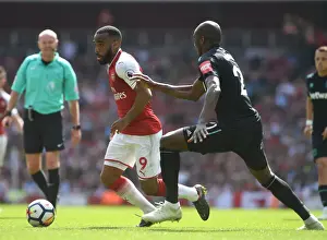 Arsenal V West Ham United 2017-18 Prints: Clash of Titans: Lacazette vs. Ogbonna in Arsenal's Battle Against West Ham