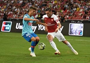 Arsenal v Atletico Madrid 2018-19 Collection: Clash of Titans: Lucas Perez vs. Oscar Pinchi - Arsenal vs. Atletico Madrid