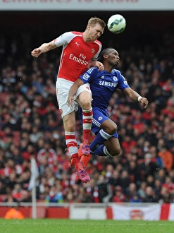 Arsenal V Chelsea 2014/15 Prints: Clash of Titans: Mertesacker vs. Drogba - Arsenal vs. Chelsea (2014/15)