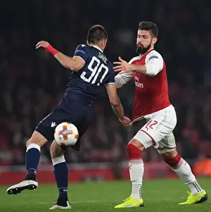 Arsenal V Red Star Belgrade 2017-18 Prints: Clash of Titans: Olivier Giroud vs Vujadin Savic - Arsenal FC vs Crvena Zvezda