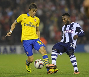 West Bromwich Albion V Arsenal 2013-14 - Capital Cup Prints: Clash of the Titans: Olsson vs Sessegnon in the Capital One Cup Showdown (West Bromwich Albion vs Arsenal)