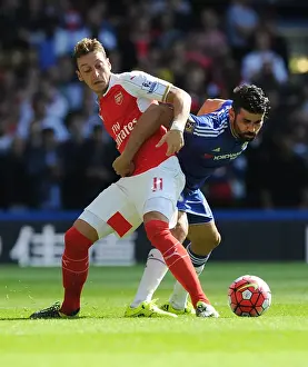 Chelsea V Arsenal 2015-16 Prints: Clash of Titans: Ozil vs Costa - Premier League Showdown: A Battle Between Arsenal's Ozil and Chelsea's Costa