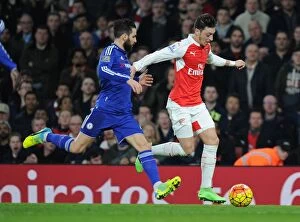 Images Dated 24th January 2016: Clash of the Titans: Ozil vs. Fabregas - Arsenal vs. Chelsea Showdown