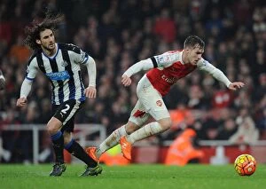 Arsenal v Newcastle United 2015-16 Collection: Clash of the Titans: Ramsey vs. Coloccini in Intense Arsenal-Newcastle Showdown
