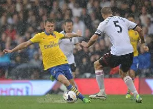 Images Dated 24th August 2013: Clash of Titans: Ramsey vs. Hangeland - Fulham vs. Arsenal, Premier League 2013-14