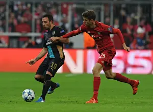 Bayern Munich V Arsenal 2015-16 Prints: Clash of Titans: Santi Cazorla vs Thomas Muller - Battle at the Allianz Arena