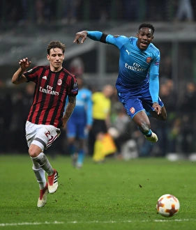 AC Milan V Arsenal 2017-18 Prints: Clash of Titans: Welbeck vs. Biglia - AC Milan vs. Arsenal, UEFA Europa League 2018