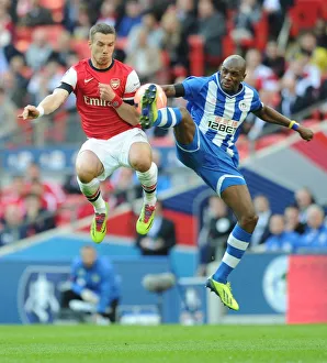 Arsenal V Wigan Athletic - FA Cup Semi Final 2014 Prints: Clash at Wembley: Lukas Podolski vs. Emerson Boyce - FA Cup Semi-Final Showdown