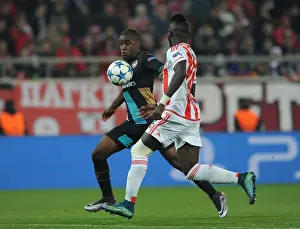 Olympiacos V Arsenal 2015-16 Prints: Clash of the Wings: Campbell vs Masuaku in the UEFA Champions League