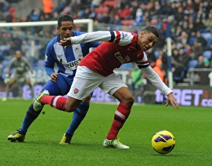 Wigan Athletic V Arsenal 2012-13 Prints: Clash of Wings: Oxlade-Chamberlain vs. Beausejour in Wigan Athletic vs. Arsenal