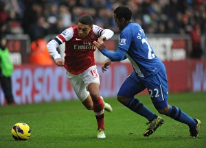 Wigan Athletic V Arsenal 2012-13 Prints: Clash of Wings: Oxlade-Chamberlain vs. Beausejour - Arsenal vs. Wigan, 2012