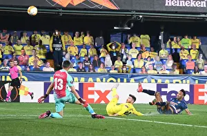 Behind Closed Doors: Aubameyang's Saved Shot - Arsenal vs. Villarreal in UEFA Europa League Semi-Final: Aubameyang's Dramatic Miss as Arsenal Battle Villarreal in Empty Stadiums