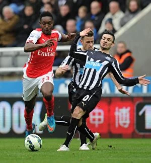 Images Dated 25th February 2009: Danny Welbeck Breaks Past Newcastle's Cabella: Arsenal vs Newcastle, Premier League 2014/15