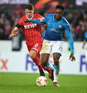 FC Koln V Arsenal 2017-18 Prints: Danny Welbeck Outmaneuvers Salin Ozcan in Arsenal's UEFA Europa League Clash with 1