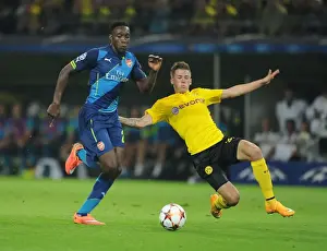 Borussia Dortmund V Arsenal 2014-15 Prints: Danny Welbeck vs. Eric Durm: A Battle in the UEFA Champions League between Borussia Dortmund and Arsenal