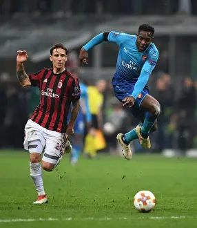 AC Milan V Arsenal 2017-18 Prints: Danny Welbeck vs. Lucas Biglia: Clash in the UEFA Europa League Round of 16 between AC Milan and Arsenal