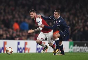 Arsenal v Red Star Belgrade 2017-18 Collection: Debuchy vs. Krsticic: A Europa League Battle at Emirates Stadium