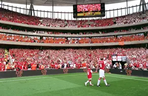 Dennis Bergkamp (Arsenal) waves to the fans on a lap of honour with his son at the end of the match