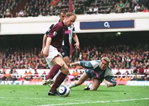 Dennis Bergkamp takes the ball away from Neil Clement and Tomasz Kuszczak