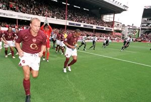 Images Dated 20th September 2005: Dennis Bergkamp and Thierry Henry (Arsenal) run out at the start of the match