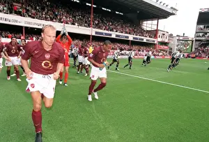 Dennis Bergkamp and Thierry Henry (Arsenal) run out at the start of the match