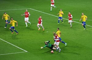 Images Dated 24th January 2014: Dramatic Podolski Goal: Arsenal's Victory Over Coventry City in FA Cup