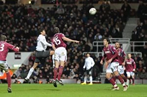 Images Dated 3rd January 2010: Eduardo heads past Matthew Upson and goalkeeper Rob Green to score the 2nd Arsenal goal