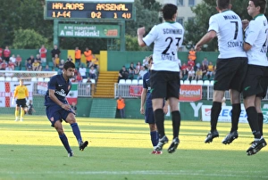 Szombathelyi Haladas v Arsenal 2009-10 Collection: Eduardo shoots past Szombathelyi goalkeeper Rozsa Daniel