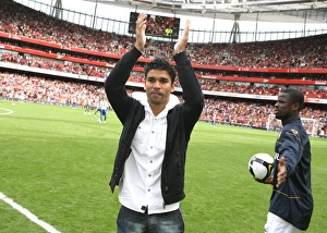 The Arsenal team wave to the fans before the match