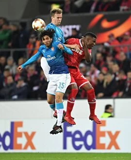 FC Koln v Arsenal 2017-18 Collection: Elneny and Holding Clash with Guirassy in Arsenal's Europa League Encounter against FC Koln