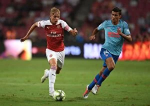 Arsenal v Atletico Madrid 2018-19 Collection: Emile Smith Rowe vs Rodrigo: Clash of the Young Stars in Arsenal vs Atletico Madrid