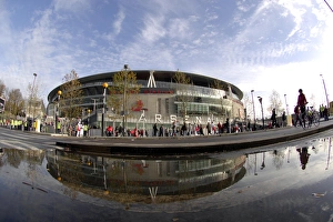 Emirates Stadium reflected in a puddle